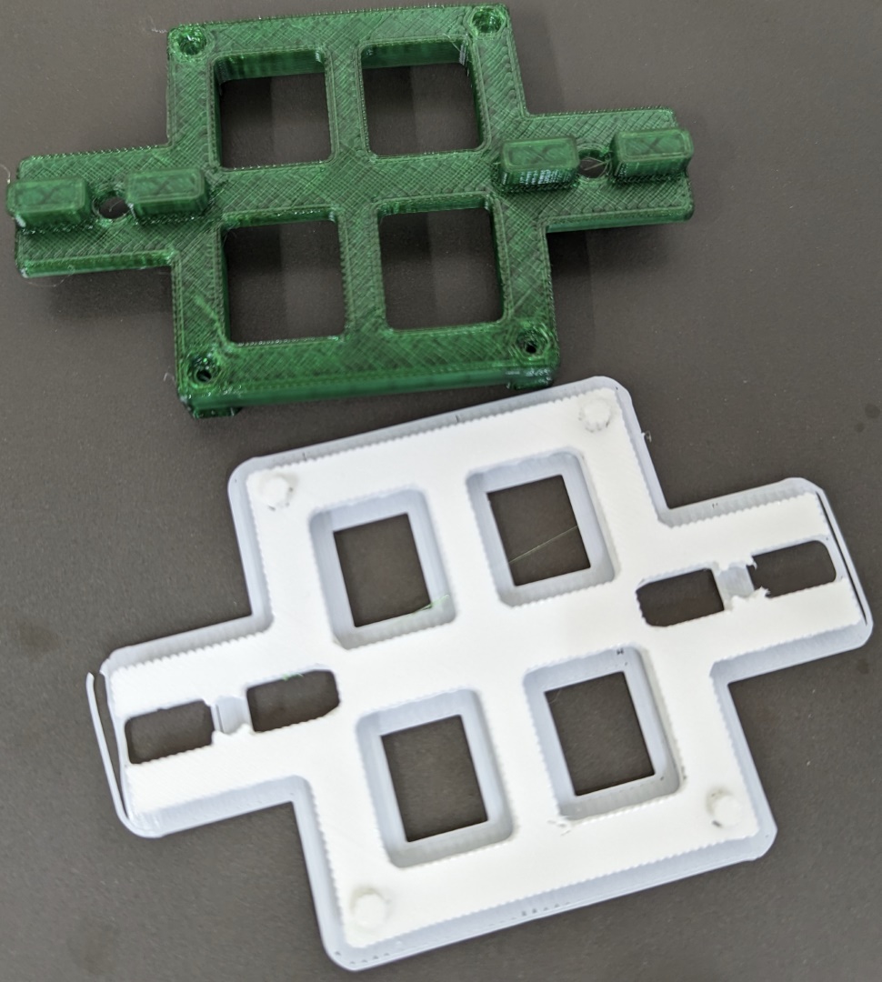 White plastic support material and green plastic part side-by-side