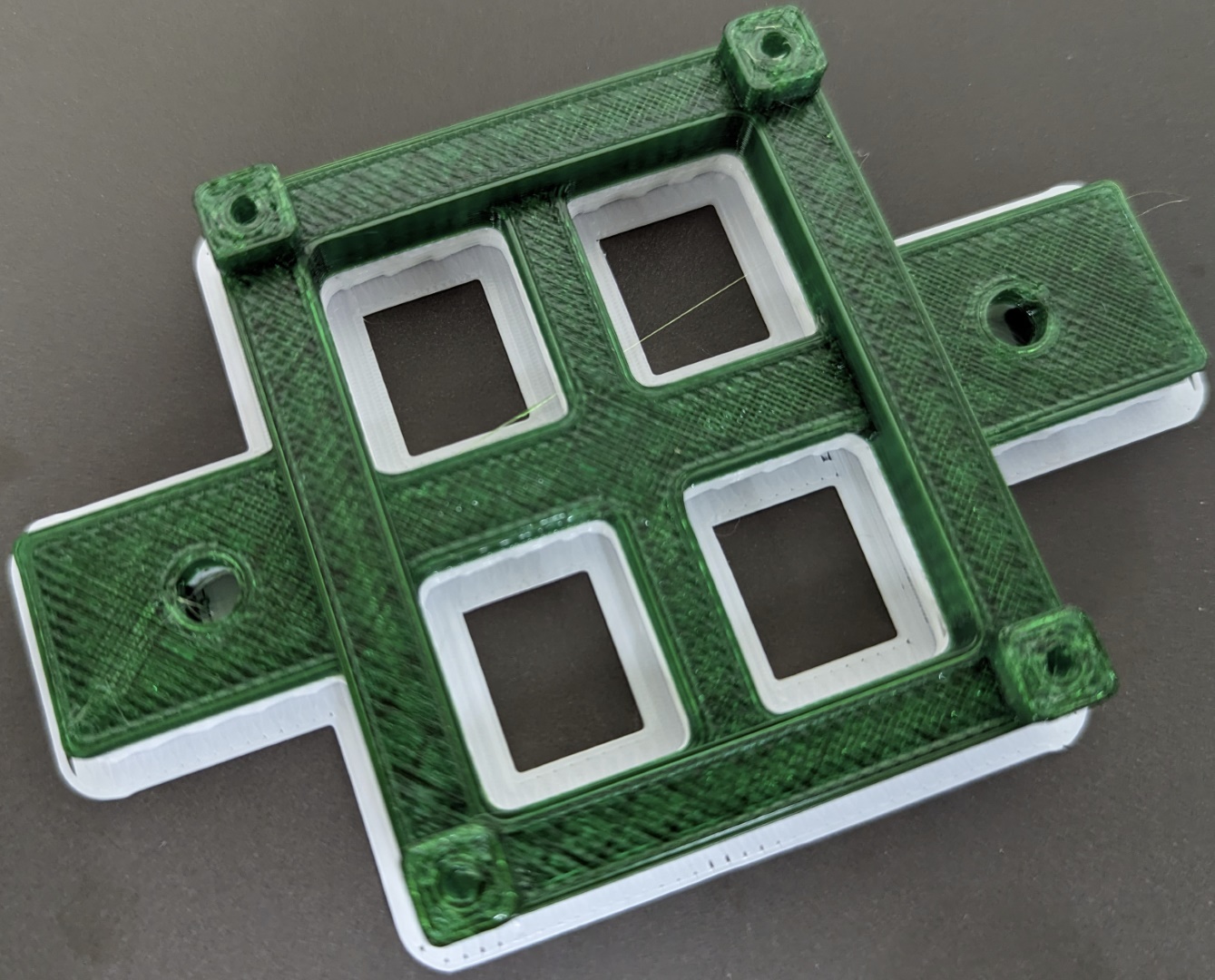 3D printed Green plastic part on top of white plastic support