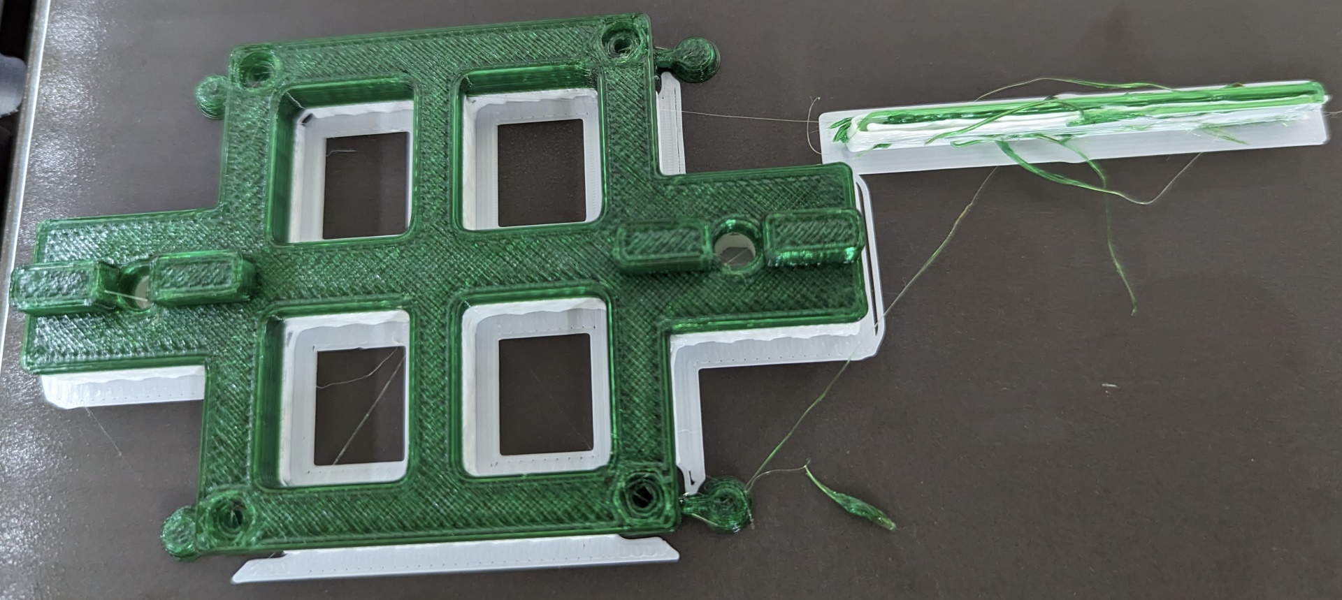 3D printed Green plastic part on top of white plastic support