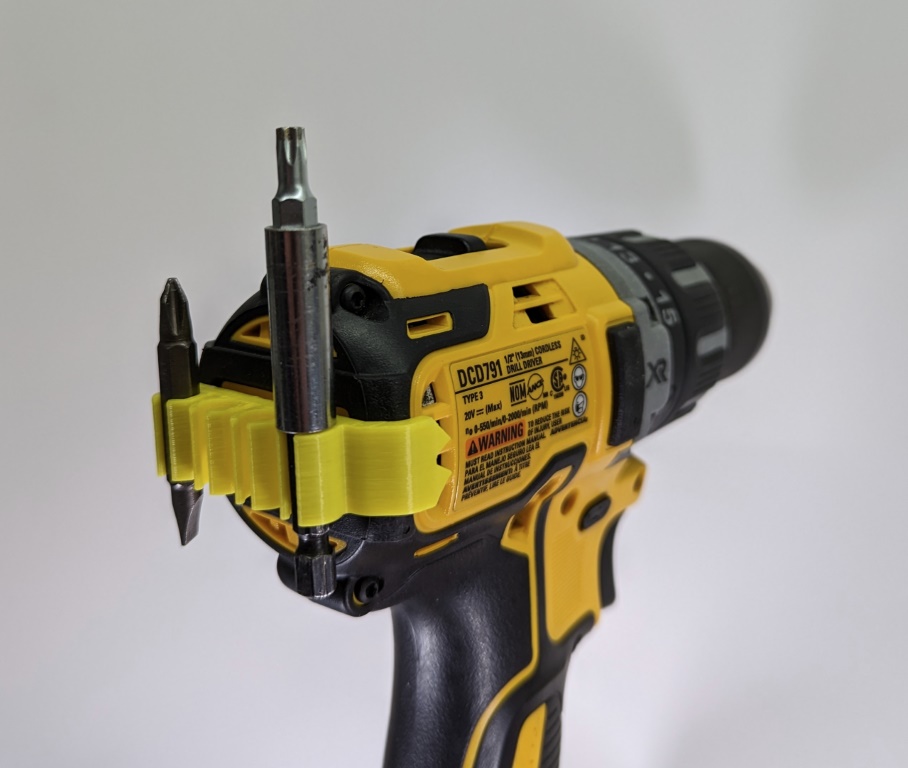 Bit holder attached to the back of a cordless drill