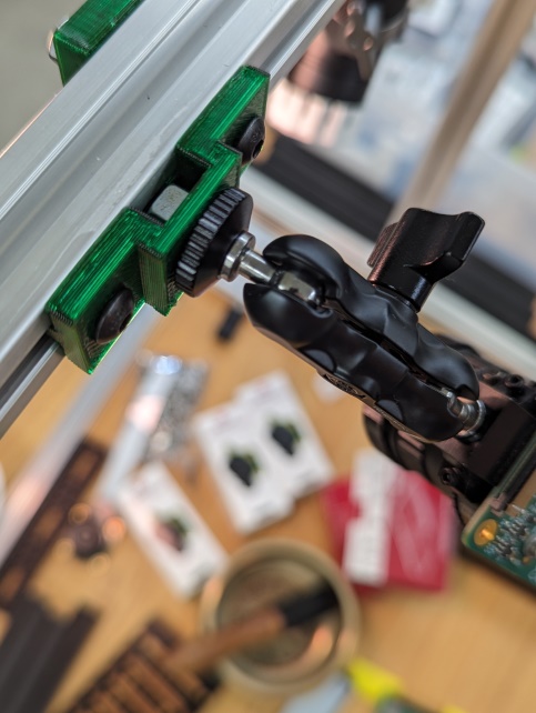 3d printed bracket holding a camera accessory on a T-Slot frame