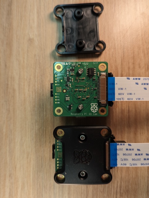 Raspberry Pi Global Shutter camera modules side-by-side, one with the back cover removed