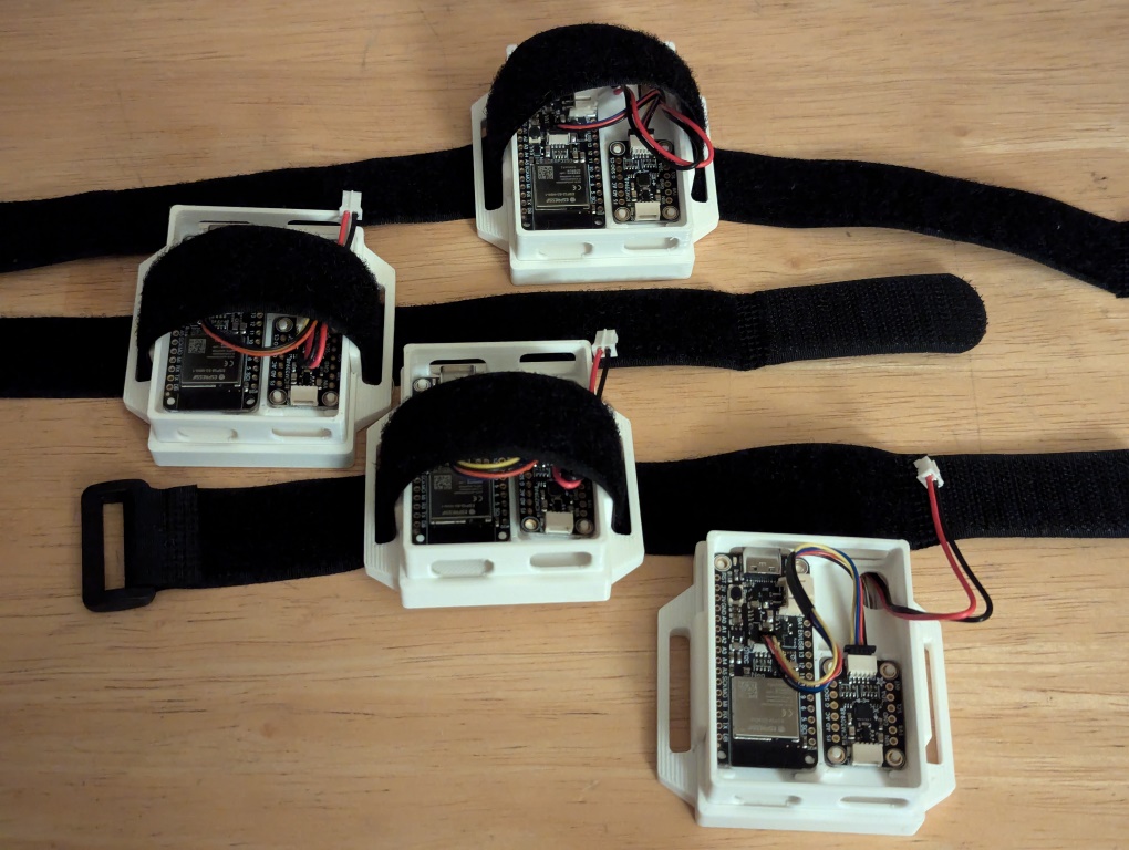 Four DIY SlimeVR trackers with velcro straps